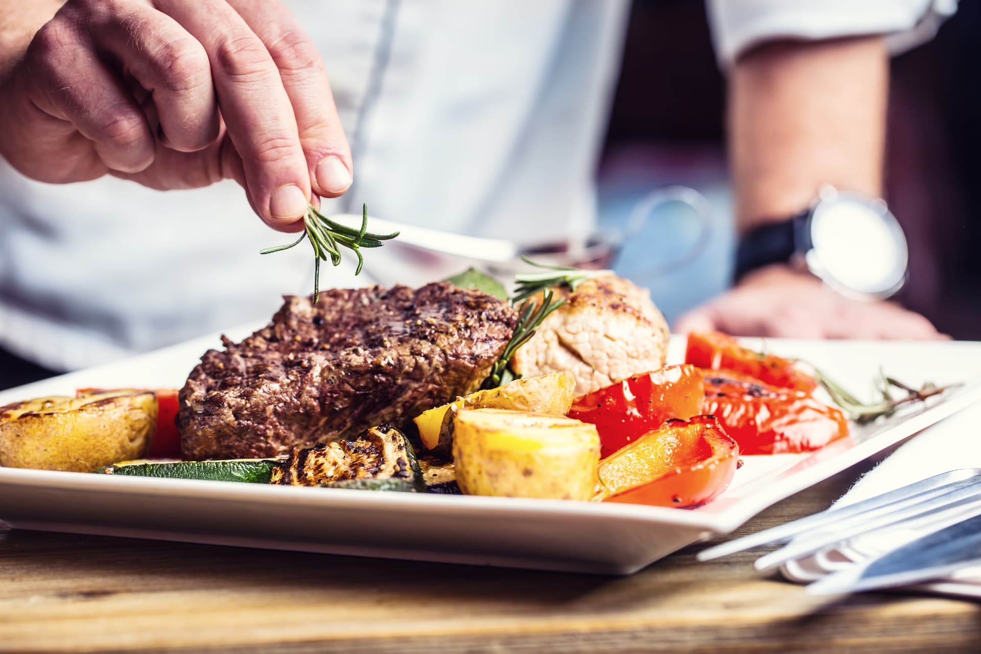 Chef plating a signature date-night dish