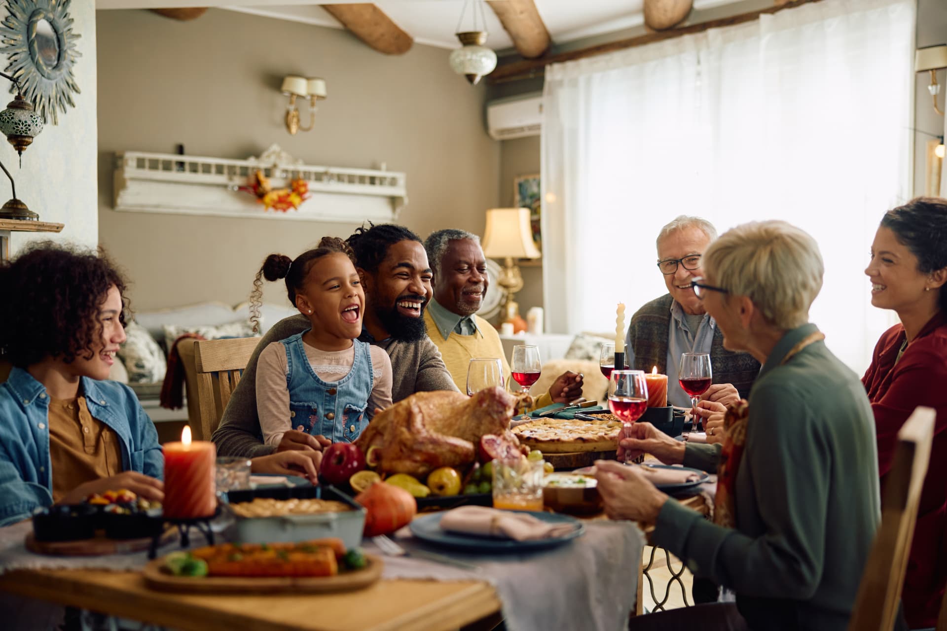 A joyful multi-generational Latino family gathered around the dinner table